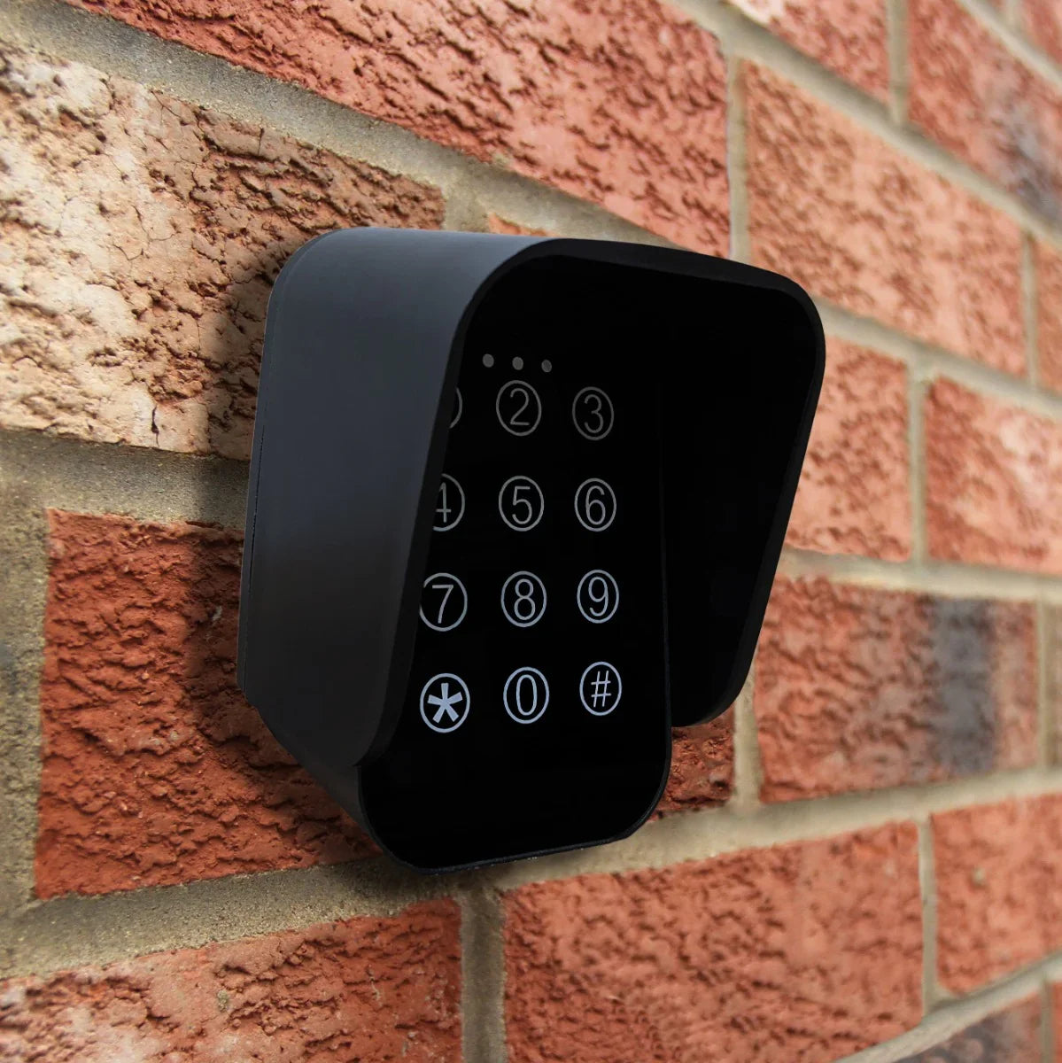 Wireless keypad for T-Mech swing gate opener, featuring a sleek black design with illuminated numeric buttons mounted on a brick wall