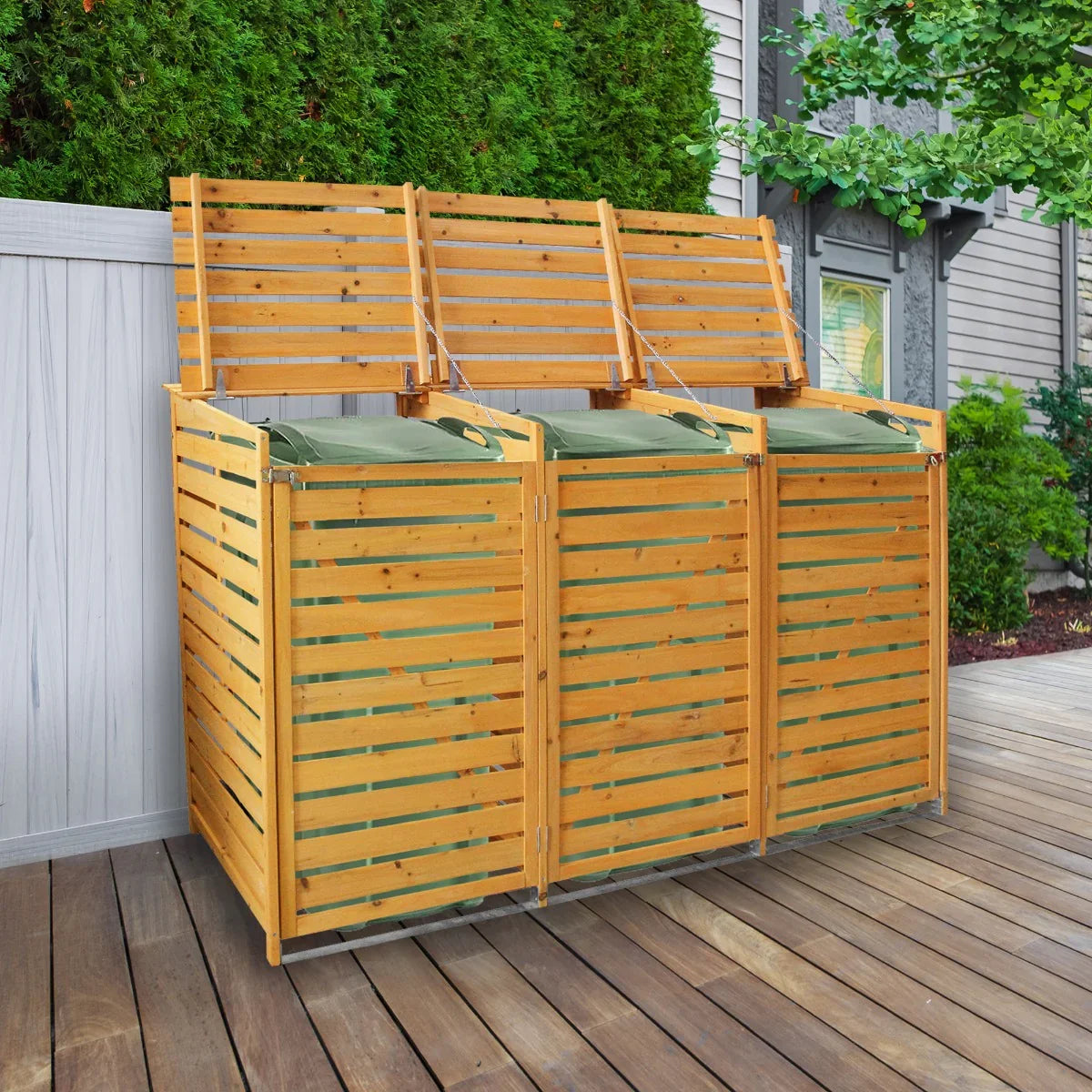 Triple wheelie bin storage unit in natural wood finish with slatted design, featuring three green lids, set on a wooden deck