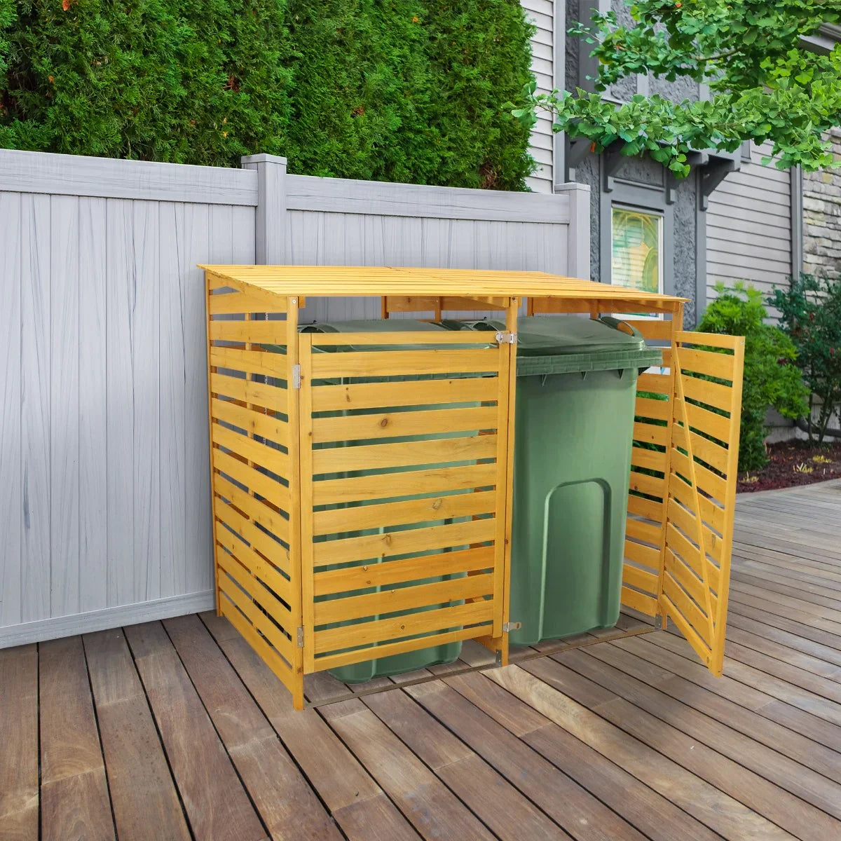 Double wheelie bin storage made of natural wood with slatted design, housing two green bins, set against a garden backdrop