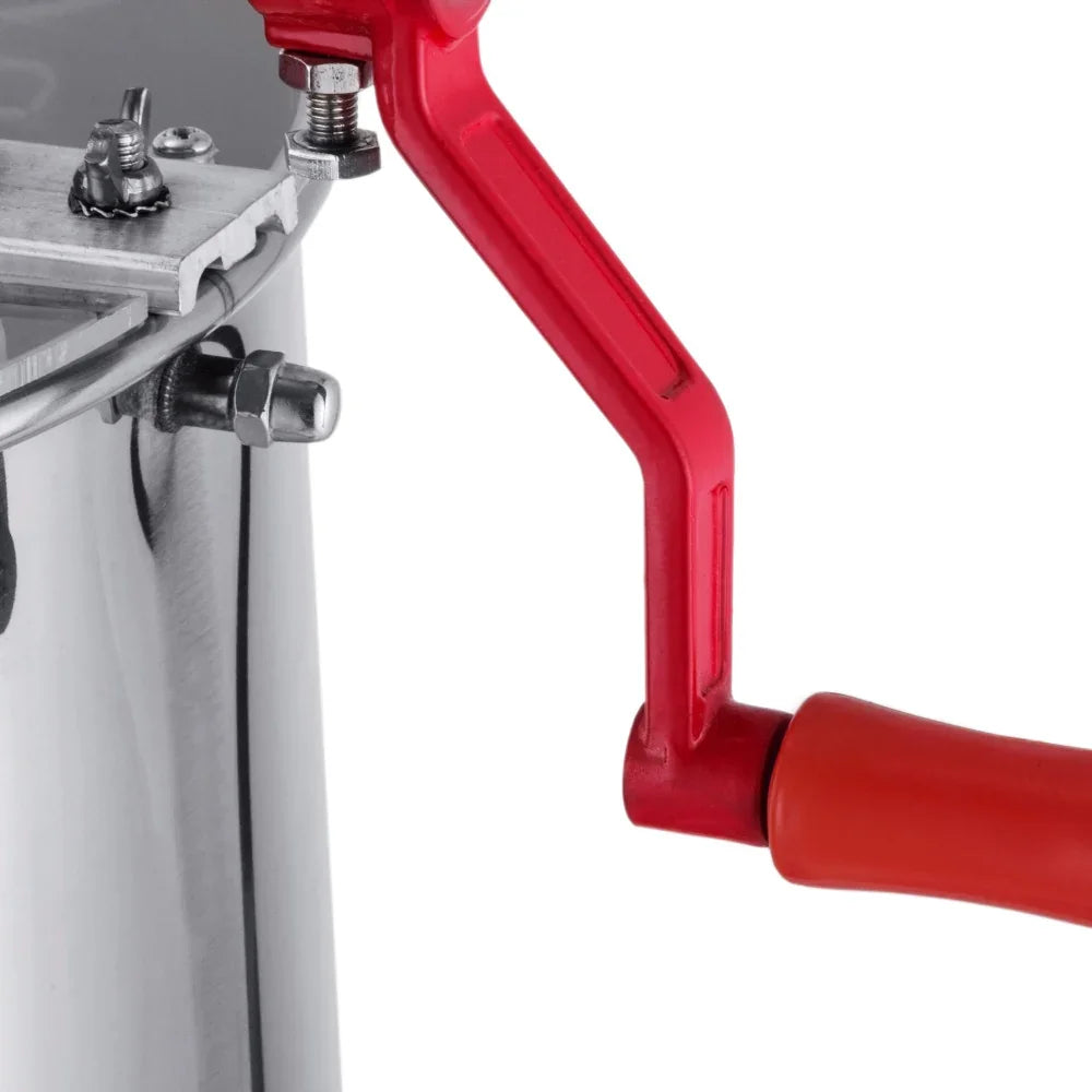 Manual honey extractor with a shiny stainless steel body, red plastic handle, and a crank mechanism for easy honey extraction