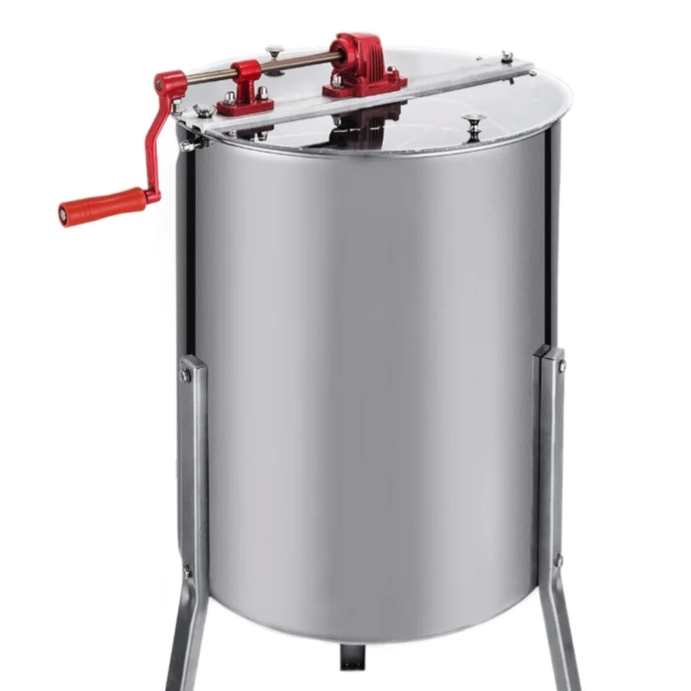 Stainless steel manual honey extractor with a red crank handle, featuring a clear lid and sturdy metal frame for easy honey extraction