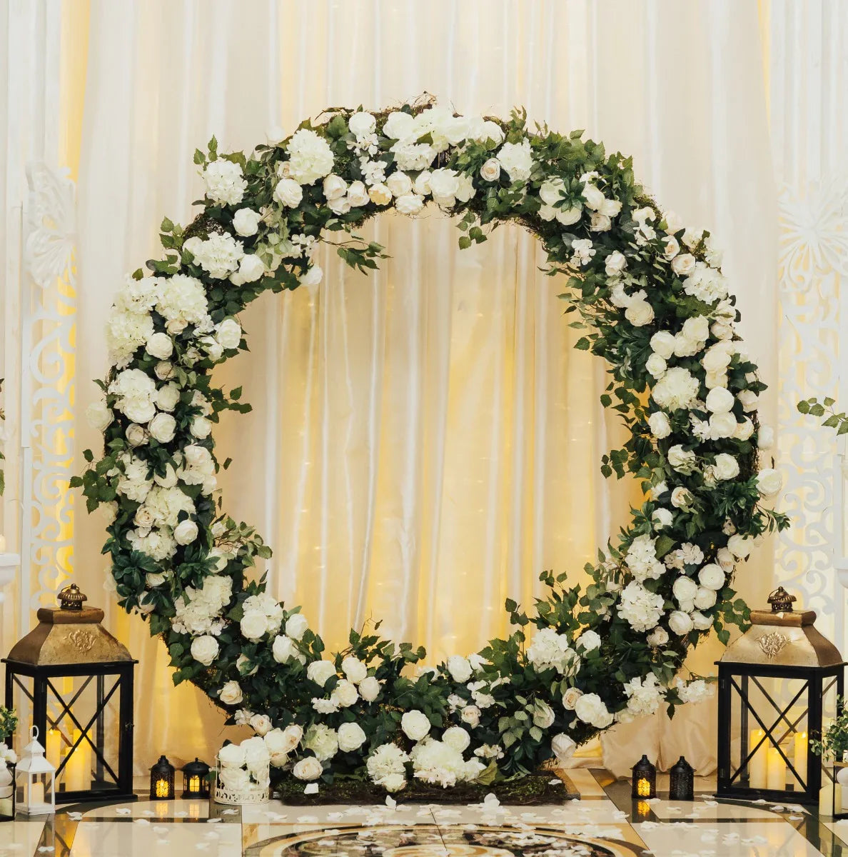 Elegant 200cm silver wedding moongate adorned with lush white flowers and greenery, framed by decorative lanterns on a soft backdrop