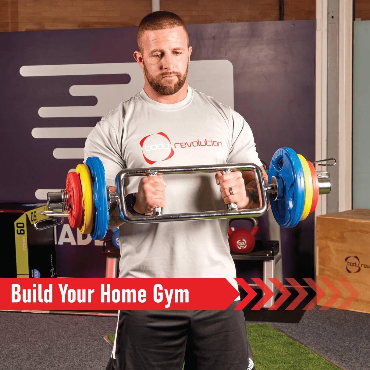 Man lifting a barbell with Olympic tri-grip rubber weight plates in vibrant colors, showcasing strength training and fitness equipment