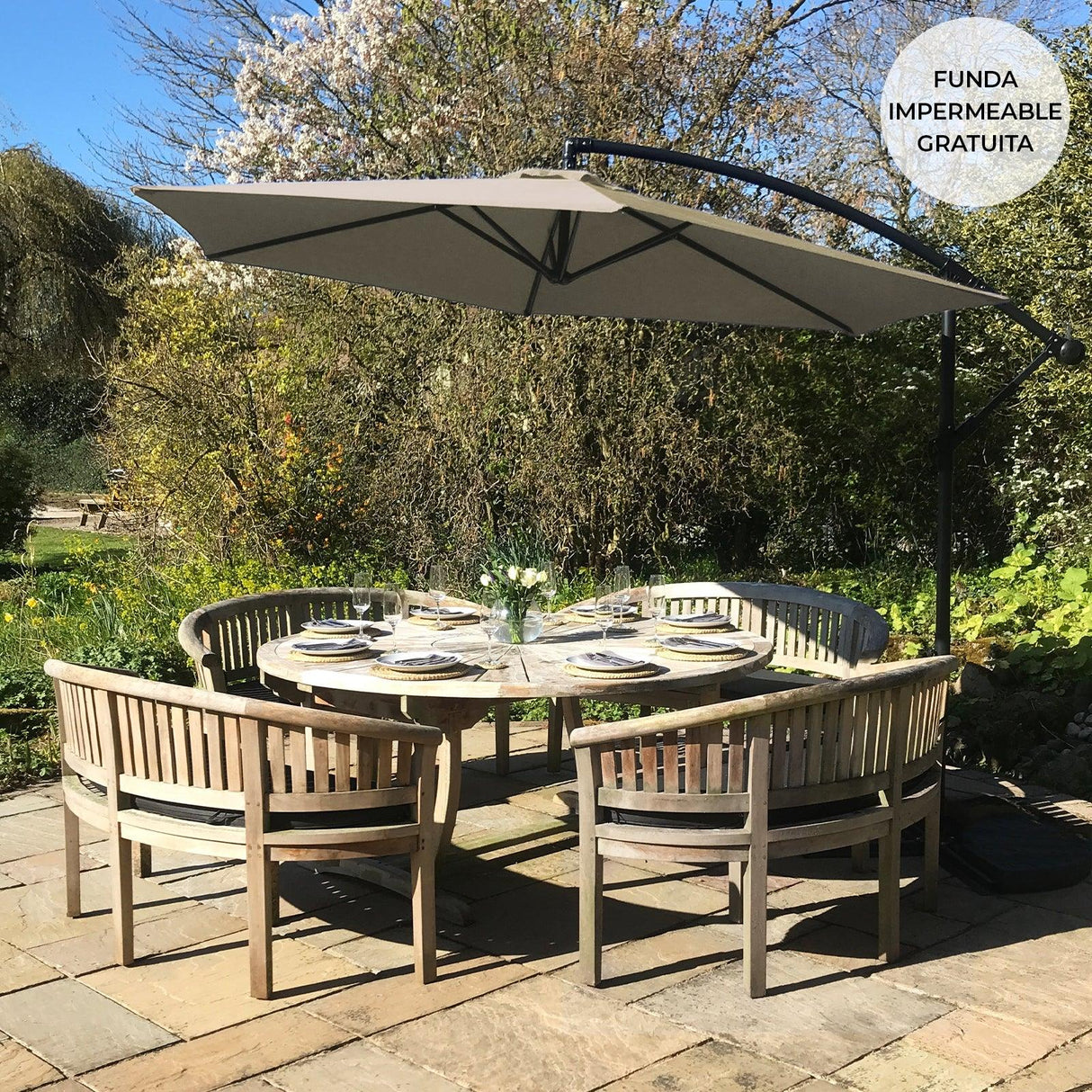 Beige cantilever parasol with a curved arm, providing shade over a round wooden dining table set in a sunny garden setting