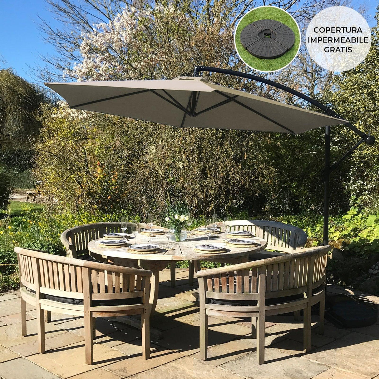 Beige cantilever parasol with a sturdy black frame, shading a round dining table set in a lush garden, surrounded by wooden chairs