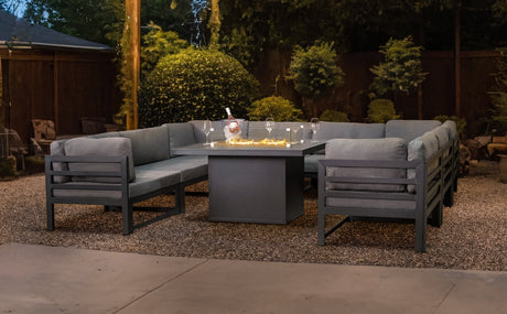 Stylish grey aluminum outdoor sectional sofa set with plush cushions, arranged around a modern fire pit table in a cozy garden setting