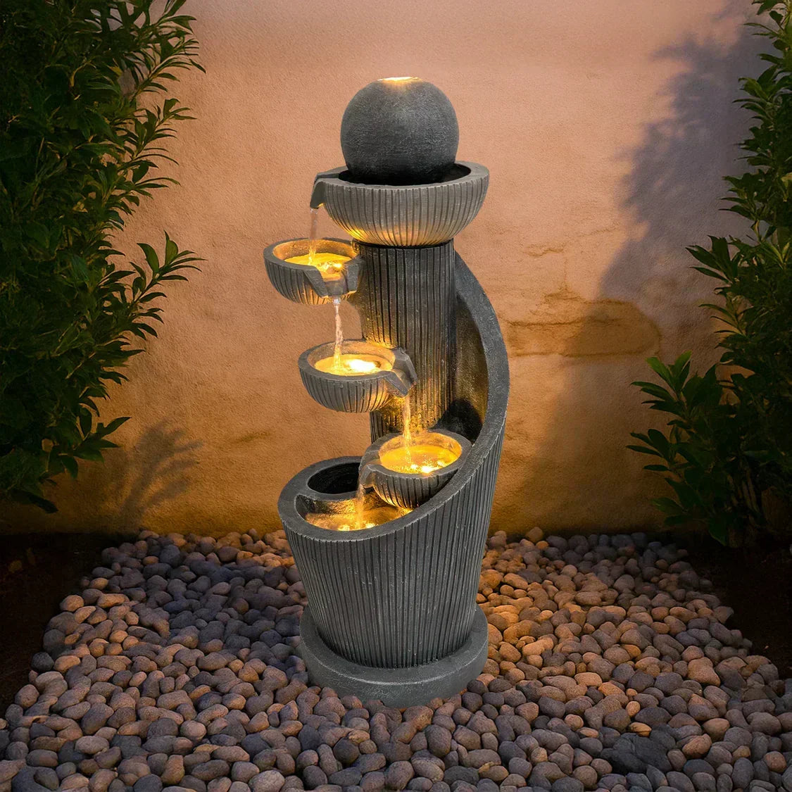 Stylish electric water feature with cascading water, illuminated bowls, and textured gray stone design, enhancing garden aesthetics