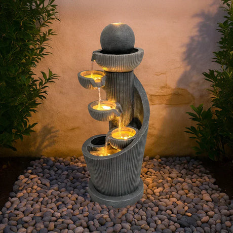 Stylish electric water feature with cascading water, illuminated bowls, and textured gray stone design, enhancing garden aesthetics