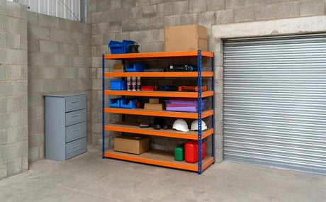 Heavy-duty orange metal shelving unit with five shelves, storing boxes, tools, and storage bins in a garage setting