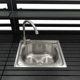 Sleek stainless steel sink with a modern faucet, set on a dark wooden countertop, ideal for outdoor kitchen setups