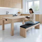 7-in-1 games table and storage bench in oak finish, featuring a sleek design, black cushioned seating, and a modern kitchen setting