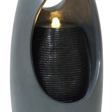 Sleek black electric water feature with a textured cylindrical fountain, softly illuminated by a warm glow, enhancing any space