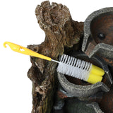 Rustic brook electric water feature with a textured tree bark design, featuring a yellow cleaning brush for maintenance