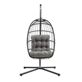 Black rattan hanging egg chair with a plush gray cushion, featuring a sleek, modern design and sturdy metal stand for indoor or outdoor use