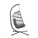 Stylish black rattan hanging egg chair with a curved metal stand and plush gray cushion, perfect for indoor or outdoor relaxation