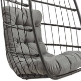 Black rattan hanging egg chair featuring a plush gray cushion, designed for comfort and stylish outdoor relaxation
