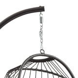 Black rattan hanging egg chair suspended from a curved metal frame, featuring a woven texture and stylish design for outdoor relaxation