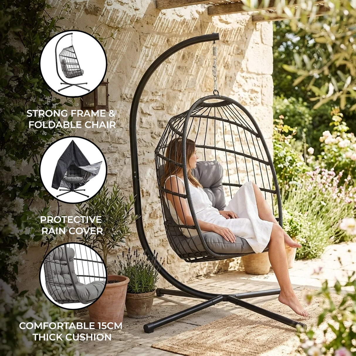 Black rattan hanging egg chair with a thick gray cushion, featuring a sturdy frame and protective rain cover, set outdoors