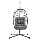 Grey rattan hanging egg chair with a plush, tufted cushion, suspended from a sturdy black metal frame, ideal for outdoor relaxation