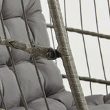 Grey rattan hanging egg chair featuring a cushioned seat, woven texture, and sturdy frame, ideal for indoor or outdoor relaxation