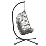 Grey rattan hanging egg chair with plush cushion, suspended from a sleek black metal frame, perfect for outdoor relaxation