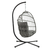 Grey rattan hanging egg chair with plush cushions, suspended from a sleek black metal frame, perfect for indoor or outdoor relaxation