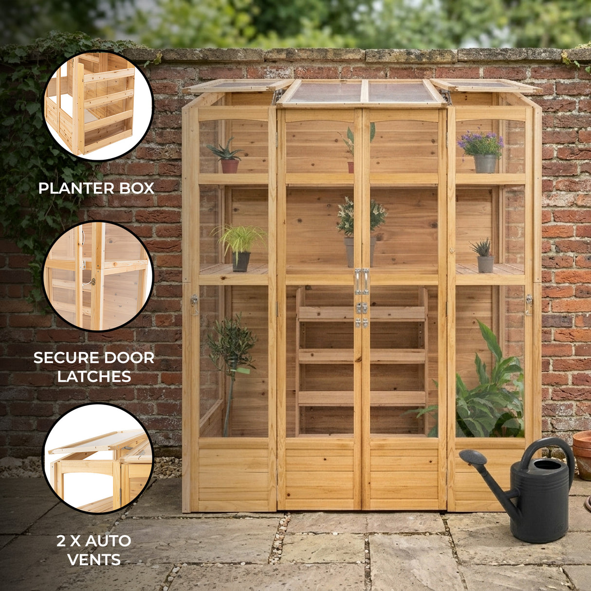 Victorian greenhouse with natural wood finish, glass panels, auto vents, and planter box, set against a brick wall backdrop