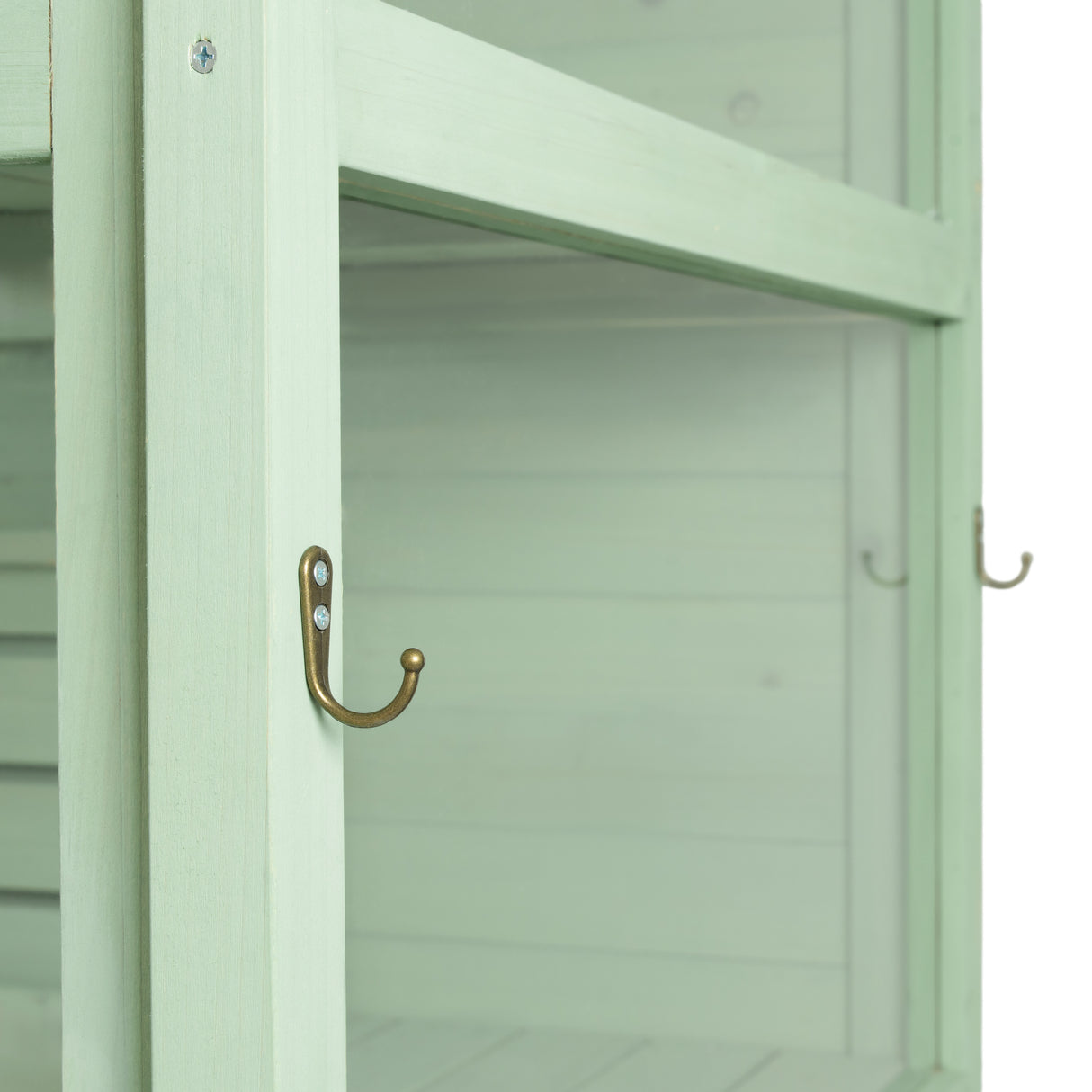 Victorian greenhouse in soft green wood, featuring a sleek design with brass hooks and a textured, natural finish