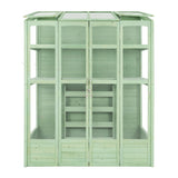 Victorian-style greenhouse in a soft green hue, featuring wooden panels, glass windows, and multiple shelves for plants