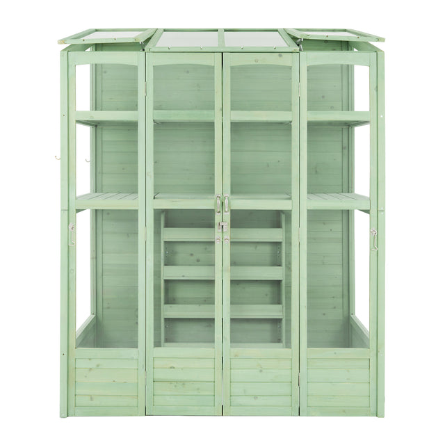 Victorian-style greenhouse in a soft green hue, featuring wooden panels, glass windows, and multiple shelves for plants