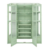 Victorian greenhouse in soft green, featuring wooden shelves, glass panels, and multiple doors for easy access and ventilation