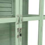 Victorian greenhouse in soft green, featuring wooden panels, sleek metal handles, and a secure lock for plant protection