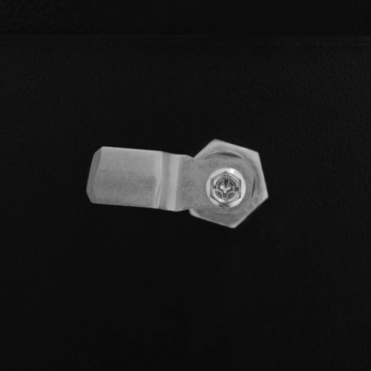 Close-up of a secure metal latch on a black gas bottle locker, showcasing its sturdy design and durable finish