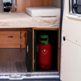 Compact black gas bottle locker securely holds a 6kg red gas bottle, designed for van interiors with wooden finishes and a textured floor