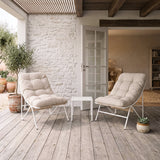 Cream 3 piece bistro set featuring two cushioned chairs and a small table, set on a wooden deck with potted plants in a cozy outdoor space