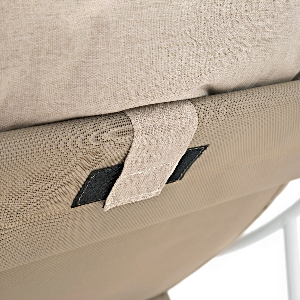 Close-up of a cream-colored bistro chair's textured fabric and sturdy frame, highlighting the stitching and supportive design