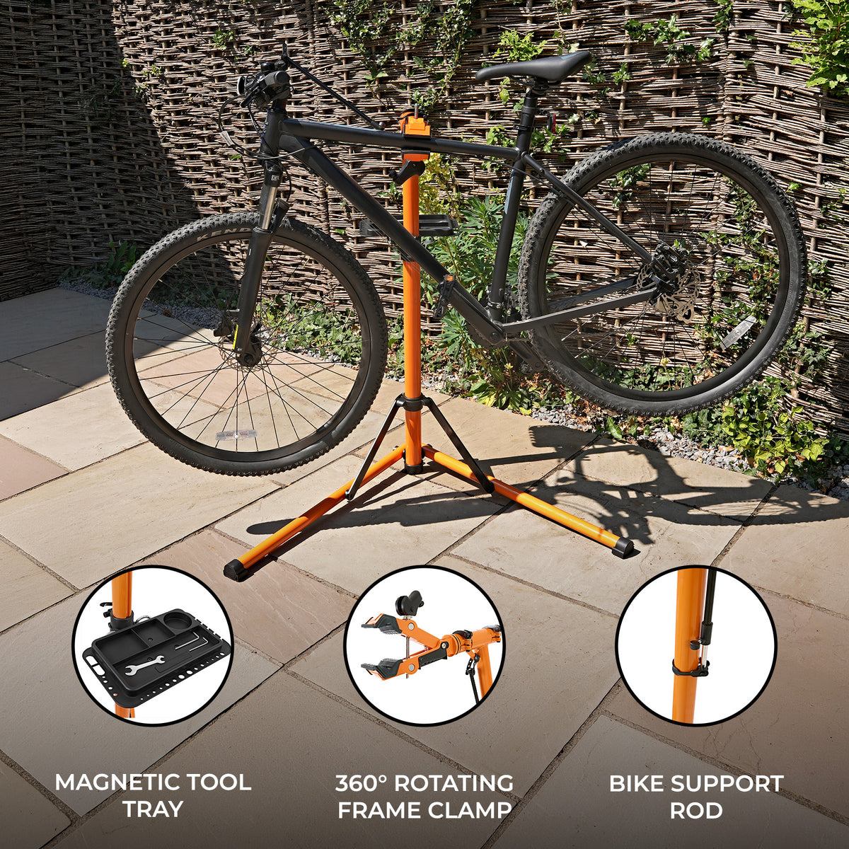 Sturdy bike mechanic repair stand with a black bicycle, featuring an orange frame, magnetic tool tray, and 360° rotating clamp
