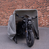 Grey medium motorbike tent featuring a durable fabric cover, protecting a sleek black motorcycle from the elements against a brick wall