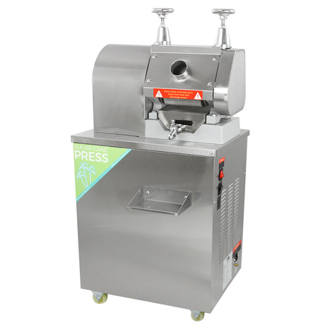 Stainless steel KuKoo sugar cane press with a sleek design, featuring a large feeding chute and sturdy wheels for mobility