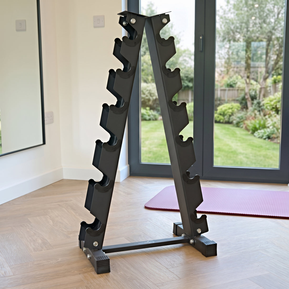 Sleek black dumbbell weight rack with six tiers, featuring a sturdy metal frame and a modern design, set in a bright home gym environment