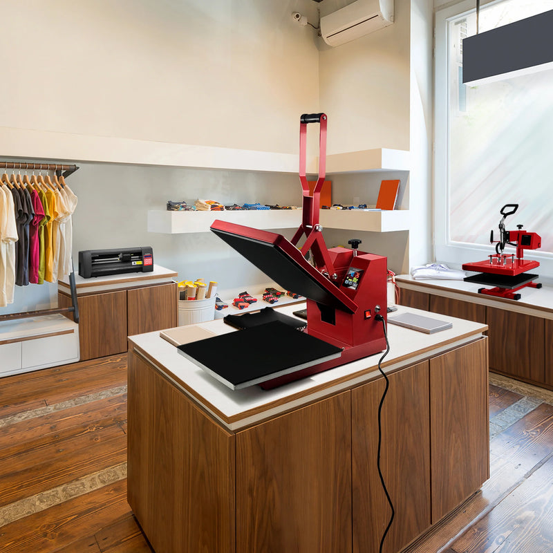 Bright red heat press machine on a wooden table in a modern shop, surrounded by colorful apparel and crafting supplies