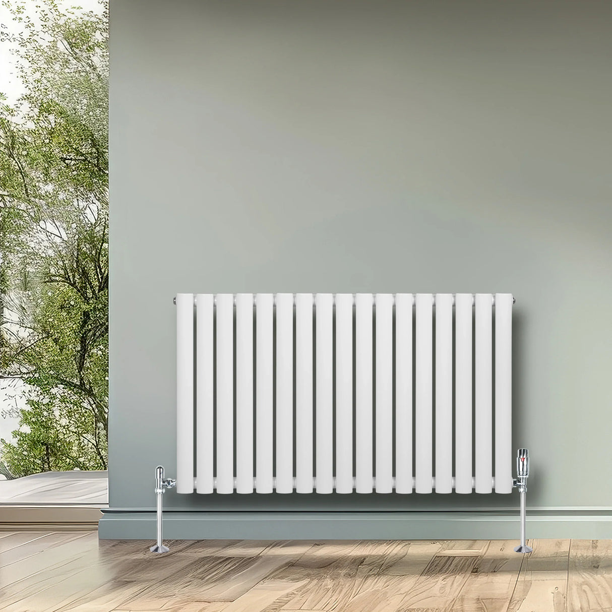 White oval single column radiator with chrome valves, 600mm x 1020mm, mounted on a light green wall in a modern interior setting