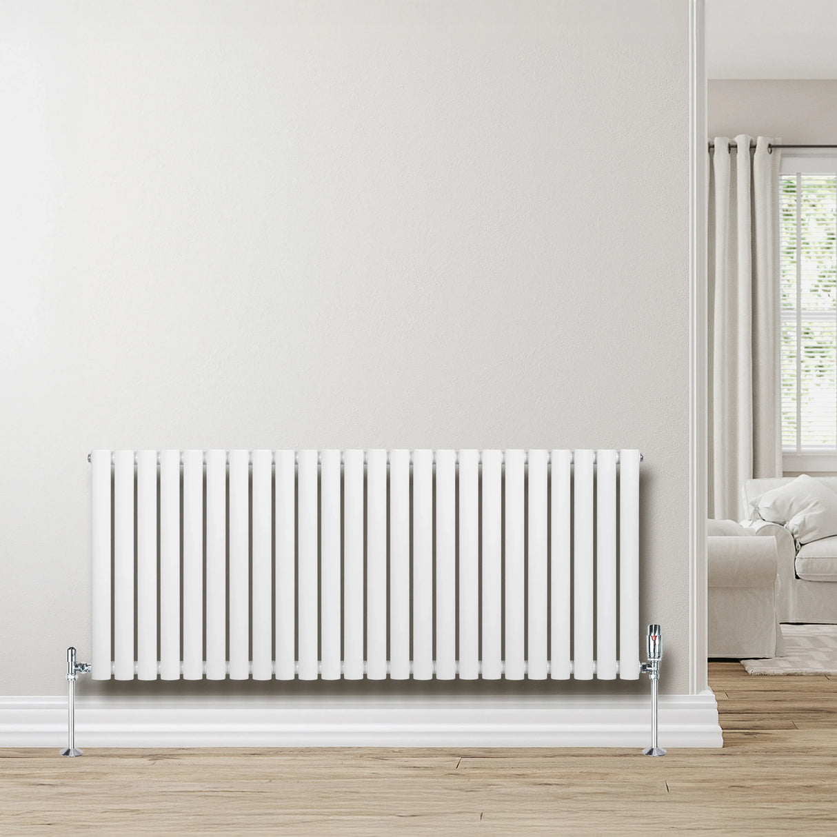 Sleek white oval single column radiator with valves, 600mm x 1440mm, mounted on a light wooden floor against a neutral wall