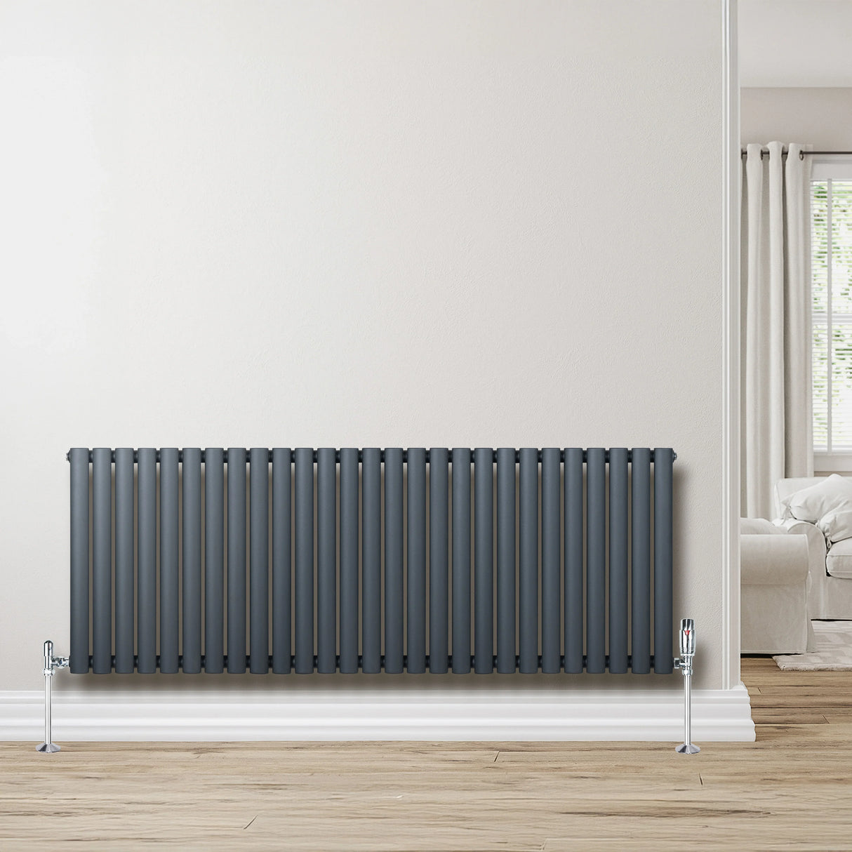 Oval single column radiator in anthracite grey, 600mm x 1620mm, featuring sleek vertical lines and polished valves, set against a light wall