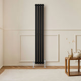 Sleek black oval single column radiator with valves, measuring 1600mm x 240mm, mounted on a light-colored wall in a modern room