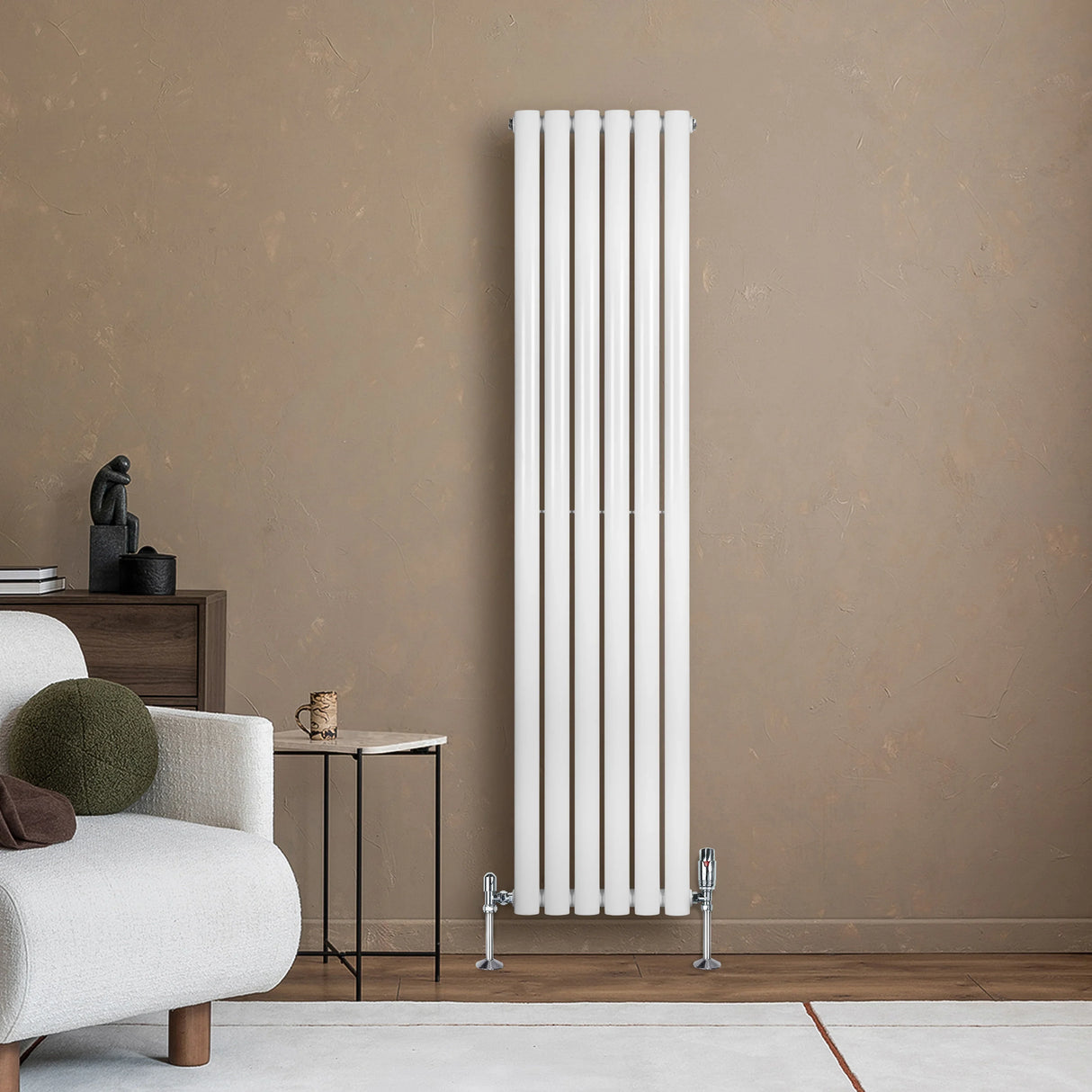 Sleek white oval single column radiator with valves, standing tall against a textured brown wall, enhancing modern interior decor
