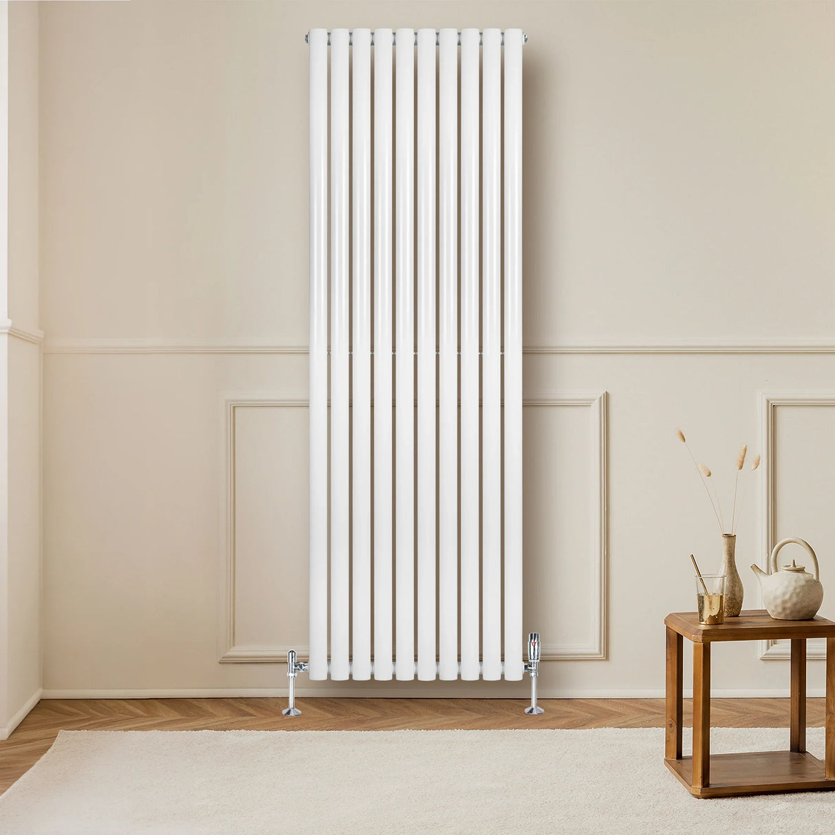 Sleek white oval single column radiator, 1800mm x 600mm, mounted on a wall in a modern room with wooden flooring and a decorative table