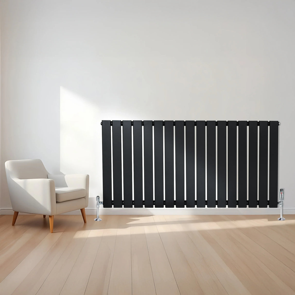 Flat black single column radiator with sleek vertical slats, paired with chrome valves, positioned beside a modern armchair in a bright room