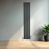 Flat single column radiator in anthracite grey, 1600mm x 280mm, featuring sleek vertical lines and chrome valves, set against a modern interior