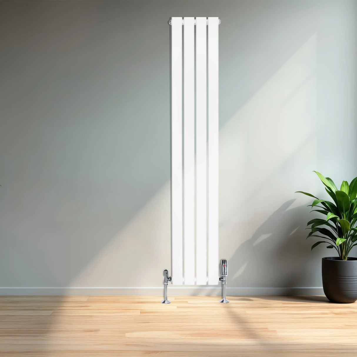 Sleek white flat single column radiator with chrome valves, standing tall against a light wall, complemented by a potted plant